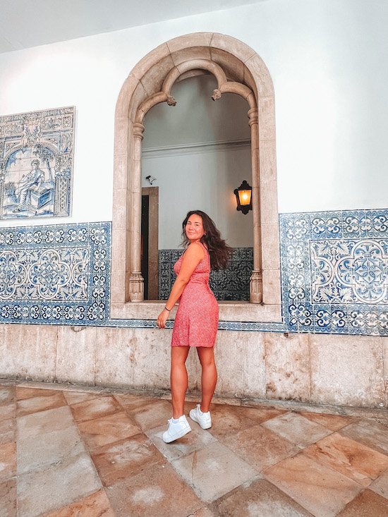 brunette in a red dress in the Azulejo Museum in Lisbon, Portugal