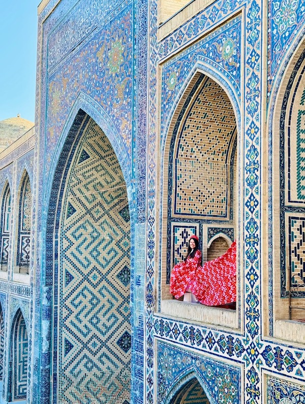 lady in red dress in Registan Square Samarkand Uzbekistan