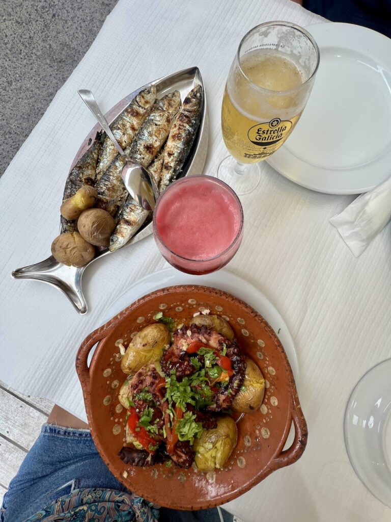 sardines and octopus with two beers, one a clear and the other a red